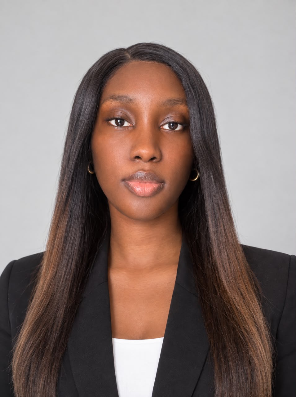 Tolulope Lawal in a black blazer against a light gray studio background